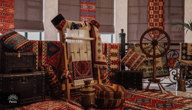 A traditional loom with vibrant, naturally-dyed wool used for Persian carpet weaving.